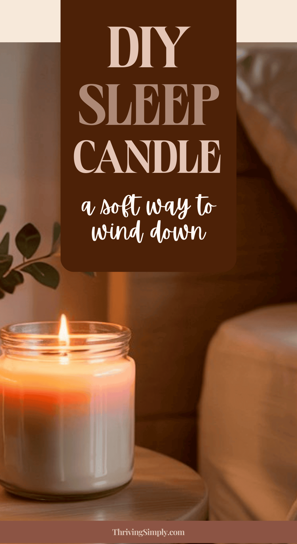 A lit DIY Sleep Candle in a glass jar sits on a bedside table next to a bed. Text above reads, DIY Sleep Candle: a soft way to wind down. A sprig of greenery completes this calming night ritual.