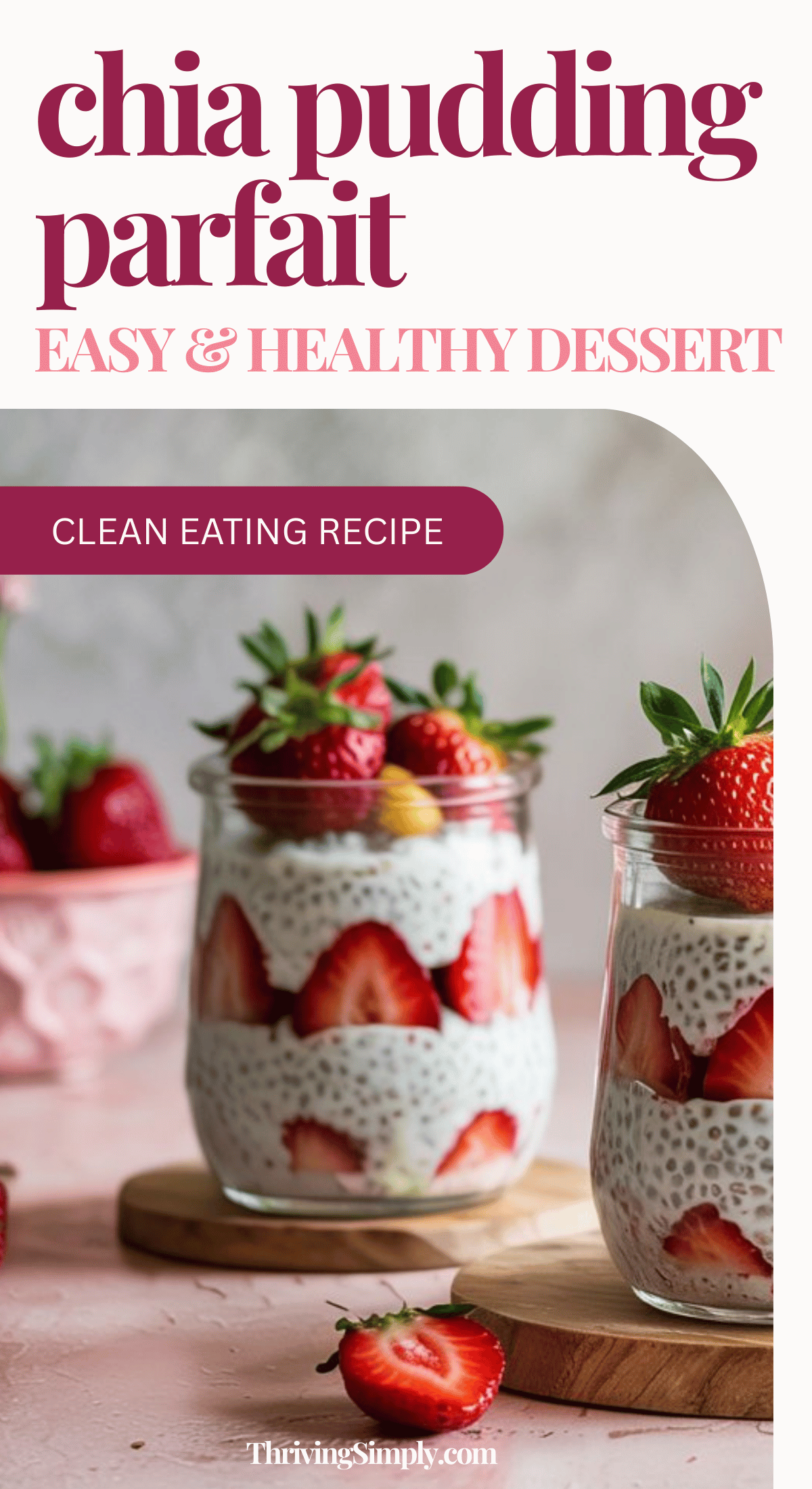 Two glass jars filled with strawberry chia pudding and layers of fresh strawberries sit on wooden boards, topped with whole berries. The soft pink background highlights this clean eating dessert recipe for a healthy chia pudding parfait.