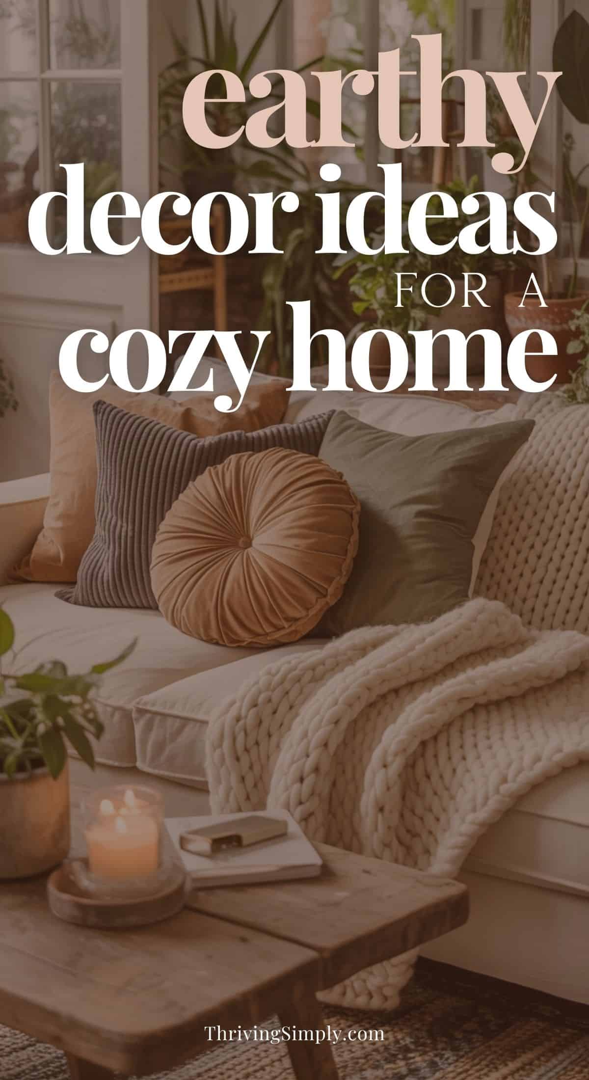 A cozy living room with a beige sofa, textured pillows, a chunky knit blanket, houseplants, and a wooden coffee table topped with candle and book. Text reads: earthy decor ideas for creating a cozy home atmosphere.