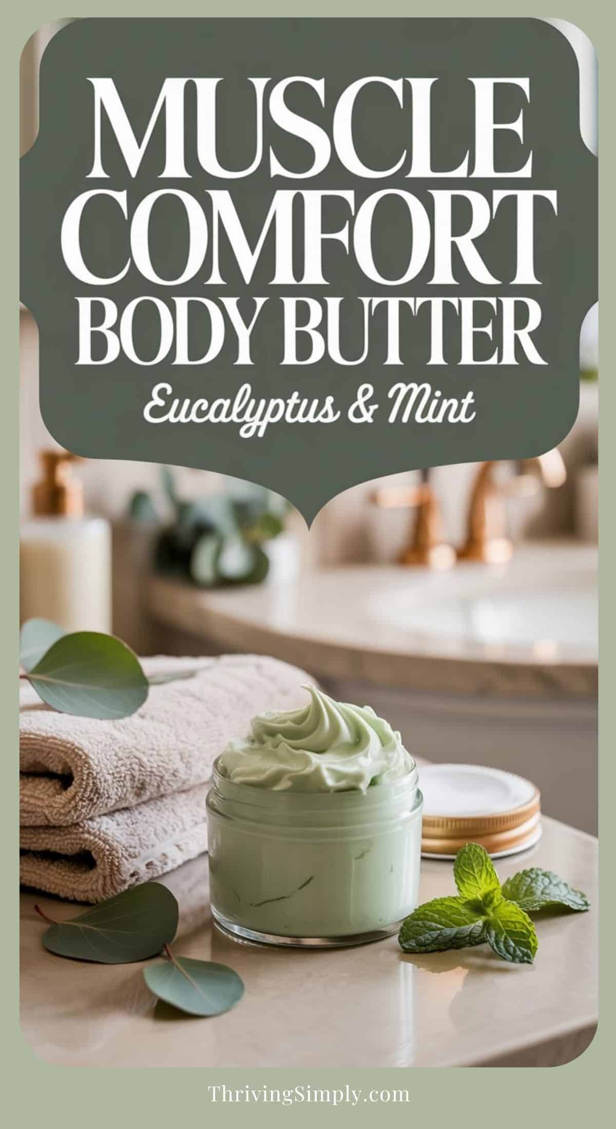 A glass jar of Body Butter sits on a folded towel beside fresh eucalyptus and mint leaves, with a bathroom sink and mirror in the background. The label reads: Muscle Comfort Body Butter, Eucalyptus & Mint.